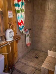 a bathroom with a shower with a shower curtain at Cabins 4 Less, No Fees in Big Bear Lake