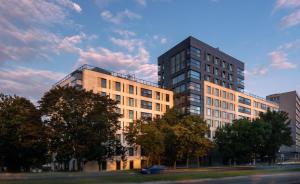 a tall building with a car parked in front of it at P&O Serviced Apartments Solec in Warsaw