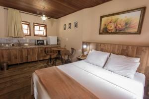 Säng eller sängar i ett rum på Pousada Alta Vista - Inhotim