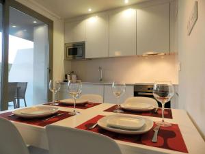 a kitchen with a table with plates and wine glasses at Panorama Beach in Torrox Costa