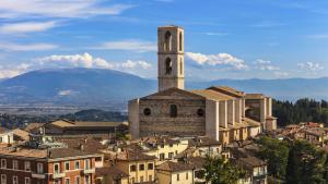 a building with a clock tower on top of a city at Residenza la Mandorla in Perugia