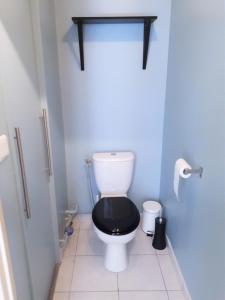 een badkamer met een toilet en een zwarte stoel bij Appartement 60m2 / Hyper Centre (Gares et Vieux Lille) in Lille