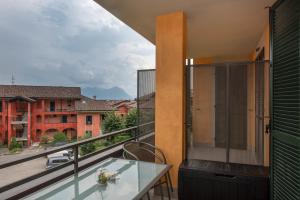 a balcony with a table and a view of a city at Be Lake Apartment in Baveno