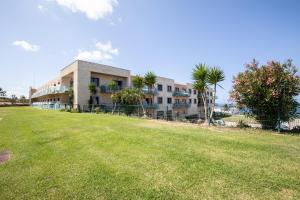 a large grassy field in front of a building at Ericeira Lounge Seaside Apartment in Ericeira