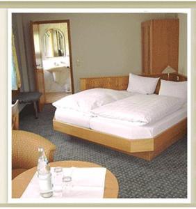 a bedroom with a large bed and a table with a table at Landhaus Karin in Freudenstadt