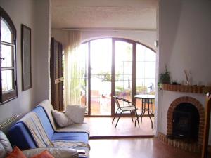 a living room with a couch and a fireplace at El Capistrano Sur in Nerja