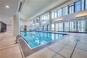 a large swimming pool in a large building at Lakefront living Downtown Toronto - Free Parking, Gym, Indoor Pool in Toronto