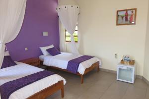 a bedroom with two beds and a window at Golo Hilltop Hotel in Labuan Bajo