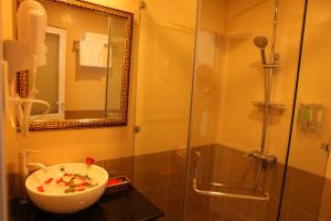a bathroom with a sink and a shower at Dalat Luxury Hotel in Da Lat