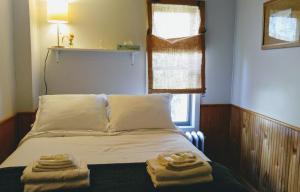 a bed with white sheets and pillows in a room at Pine Hill Arms Hotel in Pine Hill