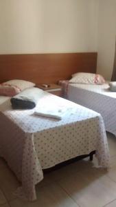 
A bed or beds in a room at Hospedagem Oliveira Vaz Lobo
