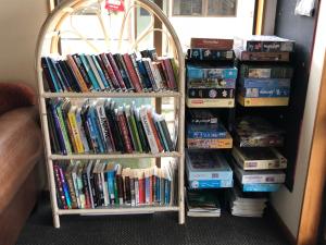 a book shelf full of books in a room at Stewart Island Backpackers in Half-moon Bay
