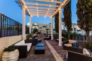 a patio with couches and tables on a building at Days Inn by Wyndham Pensacola - Historic Downtown in Pensacola