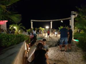 a group of people playing volleyball at night at Villaggio Mascia in Vieste