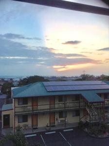 a building with solar panels on the side of it at Harbour Lodge Motel in Gladstone