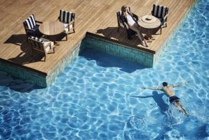 a man is swimming in a swimming pool in a swimming pool at Annabelle in Paphos