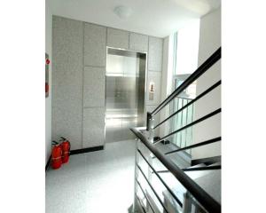 a hallway with a staircase and red shoes in a building at Gangnam Suncity Guesthouse in Seoul