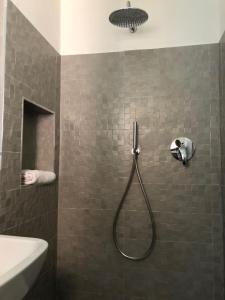 a bathroom with a shower with a shower head at Oriani 20 in Bologna