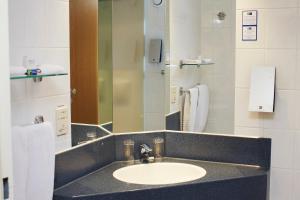 
a bathroom with a sink, toilet and mirror at Holiday Inn Express Hasselt, an IHG Hotel in Hasselt
