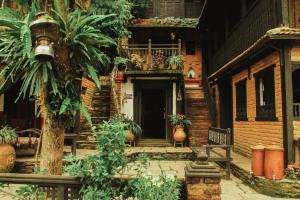 a house with a porch with plants on it at The Old Inn in Bandipur