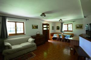 a living room with a couch and a bed at Gaber B&B in Gabrovizza San Primo