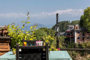 a table with a view of the mountains in the background at The Old Inn in Bandipur