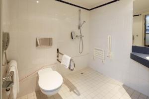 a bathroom with a toilet and a shower at Holiday Inn Express Hasselt, an IHG Hotel in Hasselt