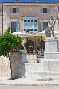 a statue of a man in front of a building at Son Cleda, house boutique adults only in Sineu