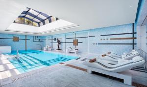 a bathroom with a swimming pool and a tub at Dinamo Hotel Baku in Baku