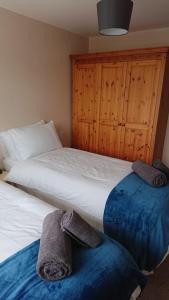 a bedroom with two beds with towels on them at Elmfield Court in Bordon