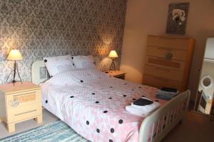 A bed or beds in a room at Cute Gite family Aucey Mont Saint Michel