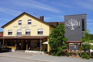 ein Hotelgebäude mit einem Schild für ein Restaurant in der Unterkunft Landhotel Schöll in Parsberg