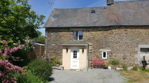 an old brick house with a white door at Cute Gite family Aucey Mont Saint Michel in Aucey-la-Plaine