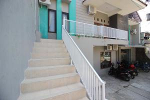 a stairway leading up to a building with motorcycles at RedDoorz near Adisucipto Airport 3 in Yogyakarta