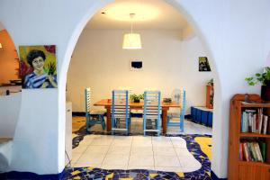a dining room with a table and blue chairs at 18 Children B&B in Sanzhi