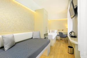 a small room with a bed and a bathroom at Ametyst Hotel Praha in Prague