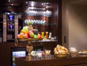a tray of fruit on a counter in a restaurant at Hotel Armoni Paris in Paris +43 photos