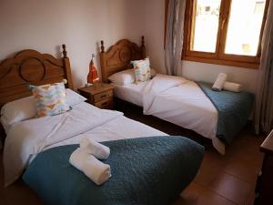 1 dormitorio con 2 camas con animales de peluche en VV Sweet Tabaiba "by henrypole home", en Los Cancajos