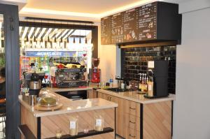 a restaurant with a counter with a bar and a menu at Centrum Suites İstanbul in Istanbul
