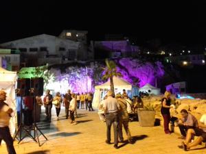 a crowd of people walking around a market at night at La Casuzza di Lara in Sciacca