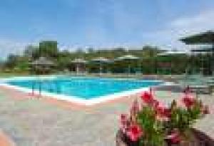 a person standing next to a swimming pool at Agriturismo La Pietraia in Poppi