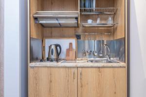 a kitchen with a sink and a counter with utensils at Oasis in Sarti