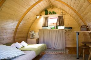 a room with two beds in a wooden cabin at Camping Oleiros in Oleiros