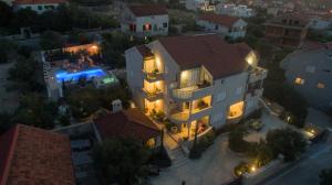 an overhead view of a large house with lights at Villa Kos Murter Apartments in Murter
