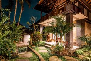 a house with a garden in front of it at The Kalangan in Ubud