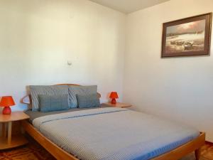 Postel nebo postele na pokoji v ubytování Apartmani Lisac