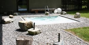 ein kleiner Pool in einem Hof mit Felsen in der Unterkunft MONTAFONLodge in Gaschurn