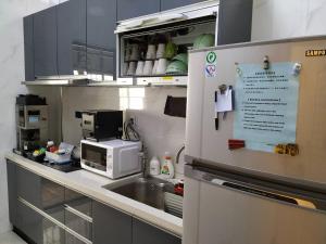 a kitchen with a sink and a microwave at Backpack Home 497 in Jinhu