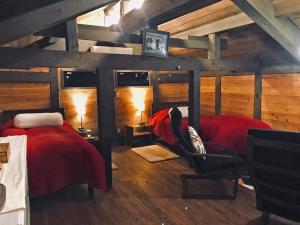 two beds in a room with wooden walls at Villa yamato in Kumamoto +8 photos