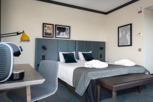 a bedroom with a large bed and a chair at Quality Hotel View in Malmö